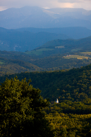 Its octogonal bell tower can be seen by those making their way down the winding road.